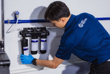 Technician servicing a water filtration system